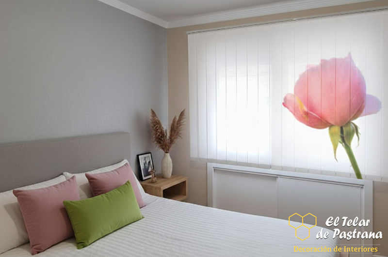 Recámara: cortina vertical con impresión digital de rosa rosa grande, cama blanca, cojines rosas y verdes, mesita de noche de madera.