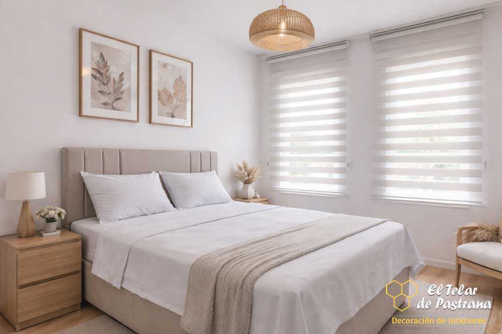 Dormitorio luminoso con estores noche y día blancos instalados en ventanas, controlando la entrada de luz natural